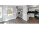 Open living area with hardwood floors connecting to the kitchen and fireplace at 100 Hugh Dr, Covington, GA 30016