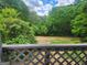 A backyard view of green trees and sky as seen from a wooden deck at 34 Pine St, Porterdale, GA 30014