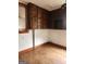 Kitchen area with wooden cabinets and wood floor at 34 Pine St, Porterdale, GA 30014
