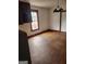 A kitchen area with wood floors, a window, and overhead lighting at 34 Pine St, Porterdale, GA 30014