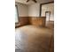 View of a living room with original wood floors and dark wood trim at 34 Pine St, Porterdale, GA 30014