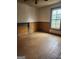 Living room with wood paneled wainscotting and a window at 34 Pine St, Porterdale, GA 30014