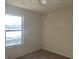 A bright bedroom with a window, ceiling fan, and carpeted floors at 10950 Wheeler Trce, Hampton, GA 30228