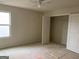 Bedroom featuring a window, ceiling fan, closet and bare floors at 10950 Wheeler Trce, Hampton, GA 30228