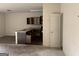 Open-concept kitchen area with dark wood cabinets and a breakfast bar at 10950 Wheeler Trce, Hampton, GA 30228