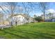 Spacious backyard featuring lush green grass and a back view of the home with a deck at 2511 Due West Nw Cir, Kennesaw, GA 30152