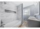 Modern bathroom features tiled shower with niche and updated vanity, showcasing elegant finishes at 2511 Due West Nw Cir, Kennesaw, GA 30152