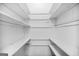 Walk-in closet featuring built-in shelving throughout at 2511 Due West Nw Cir, Kennesaw, GA 30152