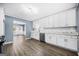 Bright kitchen features white cabinetry, gray counters, stainless steel dishwasher, and hardwood floors at 2511 Due West Nw Cir, Kennesaw, GA 30152
