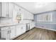 Bright kitchen with white cabinetry, stainless steel appliances, and a window over the sink providing natural light at 2511 Due West Nw Cir, Kennesaw, GA 30152