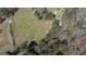 Aerial view of the property featuring large lawn, wooded area, and driveway at 689 Hardin Rd, Temple, GA 30179