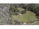 Aerial shot capturing the property's expansive grounds, nestled among tall trees and lush greenery at 689 Hardin Rd, Temple, GA 30179