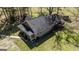 Aerial view showcases the home with surrounding land and detached garage at 689 Hardin Rd, Temple, GA 30179