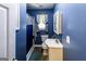 Cozy full bathroom featuring a shower-tub, vanity, and decorative blue walls at 689 Hardin Rd, Temple, GA 30179