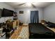 This bedroom includes laminate floors, large TV, and closet space at 689 Hardin Rd, Temple, GA 30179
