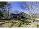 Exterior view of a charming brick home with mature landscaping and a cozy front porch at 689 Hardin Rd, Temple, GA 30179