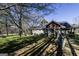 Rear exterior view of a house with a deck, lush greenery, and mature trees at 689 Hardin Rd, Temple, GA 30179