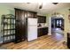 Bright kitchen with dark wood cabinets and stainless steel appliances at 689 Hardin Rd, Temple, GA 30179
