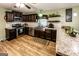 Modern kitchen with stainless steel appliances, farmhouse sink, granite countertops and dark wood cabinets at 689 Hardin Rd, Temple, GA 30179