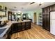 Spacious kitchen with ample counter space, dark wood cabinets, and wood flooring at 689 Hardin Rd, Temple, GA 30179