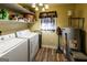 Functional laundry room with washer, dryer, storage shelves, and water heater at 689 Hardin Rd, Temple, GA 30179