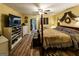 Beautiful main bedroom featuring a canopy bed, laminate floors, and ensuite bathroom at 689 Hardin Rd, Temple, GA 30179