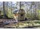 Wooden shed featuring a charming heart accent on the door, surrounded by a lush, green yard at 689 Hardin Rd, Temple, GA 30179