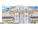 Inviting two-story townhouse featuring traditional architectural details and manicured landscaping at 9453 Cypress Ln, Jonesboro, GA 30238