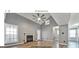 Bright living room with fireplace, vaulted ceiling, ceiling fan, and wood flooring at 9453 Cypress Ln, Jonesboro, GA 30238