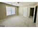 A bright bedroom with neutral carpet, a large window, and freshly painted walls and trim at 2481 Weatherstone Cir, Conyers, GA 30094