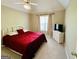 Cozy bedroom features red comforter, white furniture, and a large window for ample light at 2481 Weatherstone Cir, Conyers, GA 30094