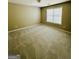 A bedroom features neutral walls, carpeting, and a window providing natural light at 2481 Weatherstone Cir, Conyers, GA 30094