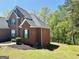 Traditional brick home with green lawn, a dark roof, and lush, natural surroundings at 2481 Weatherstone Cir, Conyers, GA 30094