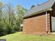 An exterior angle captures the brick design of the house, showing the roof, siding, and landscaping details at 2481 Weatherstone Cir, Conyers, GA 30094