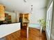Eat-in kitchen featuring hardwood floors, light wood cabinetry, and a modern glass table at 2481 Weatherstone Cir, Conyers, GA 30094