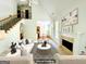Bright, airy living room featuring a fireplace and a staircase with wrought iron spindles at 2481 Weatherstone Cir, Conyers, GA 30094