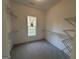 Spacious walk-in closet with shelving and window, providing ample storage and natural light at 2481 Weatherstone Cir, Conyers, GA 30094