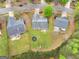 Aerial view showcasing the large backyard, and surrounding mature trees at 105 Lantana Dr, Locust Grove, GA 30248
