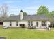 Spacious backyard with patio, well-maintained lawn, and mature trees at 105 Lantana Dr, Locust Grove, GA 30248