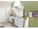 Bright bathroom featuring a large vanity, ample counter space, and well lit with a large arched window at 105 Lantana Dr, Locust Grove, GA 30248