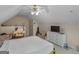 Neutral bedroom with angled ceilings, ceiling fan, and natural light at 105 Lantana Dr, Locust Grove, GA 30248