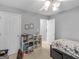 Neutral bedroom features a floral patterned bed, two white doors, and a white ceiling fan with lights at 105 Lantana Dr, Locust Grove, GA 30248