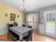 Cozy dining area with a chandelier, natural lighting, hardwood floors, and table setting at 105 Lantana Dr, Locust Grove, GA 30248