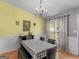 Charming dining area features wainscotting, chandelier, and ample natural light at 105 Lantana Dr, Locust Grove, GA 30248