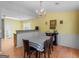 Charming dining room with hardwood floors, a chandelier, and a table set for a cozy meal at 105 Lantana Dr, Locust Grove, GA 30248