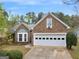 Charming brick home featuring a two-car garage, bay window and landscaped front yard at 105 Lantana Dr, Locust Grove, GA 30248