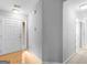 Bright foyer with hardwood flooring, a white front door with glass accents, and neutral wall color at 105 Lantana Dr, Locust Grove, GA 30248