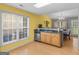 Charming eat-in kitchen with bright yellow accent wall, plenty of natural light and stainless appliances at 105 Lantana Dr, Locust Grove, GA 30248
