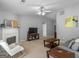 Open living room featuring a fireplace, large windows, hardwood floors, and comfortable furniture at 105 Lantana Dr, Locust Grove, GA 30248