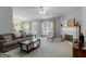 Spacious living room featuring a fireplace, a comfortable couch, large windows, and inviting natural light at 105 Lantana Dr, Locust Grove, GA 30248
